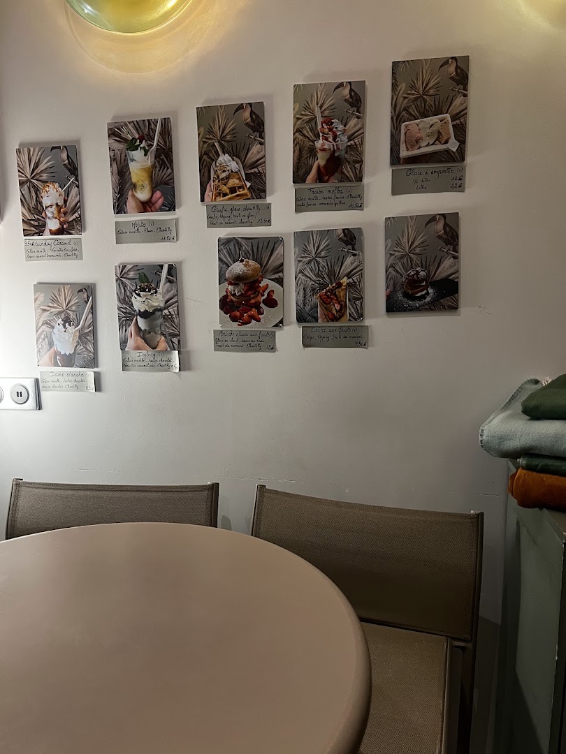 Une petite salle de Jolly avec tables, chaises et photographies au mur